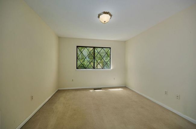 Carpeted empty room featuring baseboards | Image 10