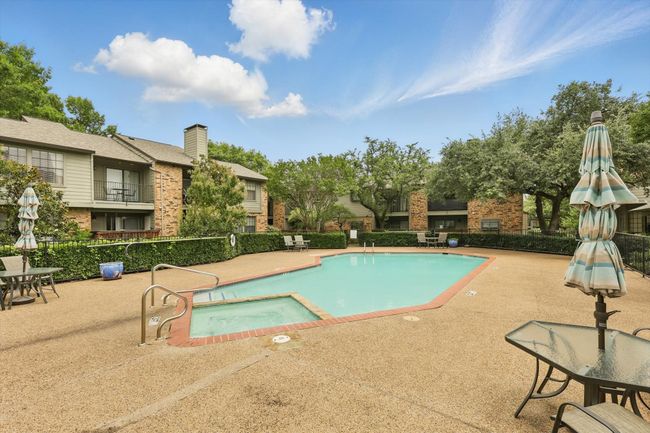 View of swimming pool featuring a patio area and a pool with connected hot tub | Image 20