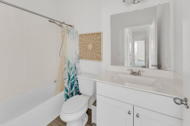 The guest bathroom is thoughtfully designed with modern fixtures and a functional layout, perfect for visitors. | Image 20