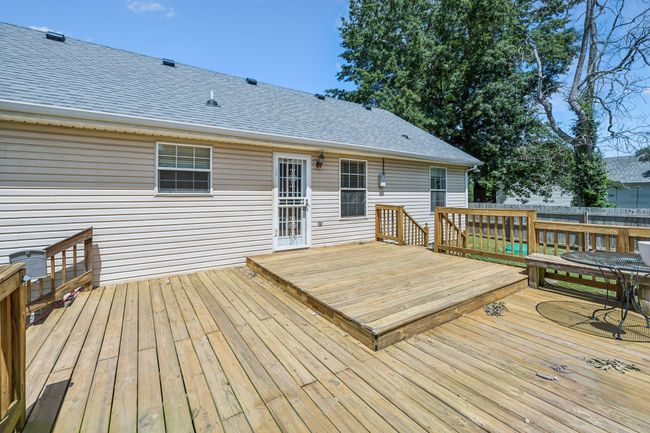 The large backyard boasts a recently built multi-leveled deck with comfortable bench seating perfect for your summer gatherings! 2095 Bolden Drive, Murfreesboro, TN 37127 | Image 21