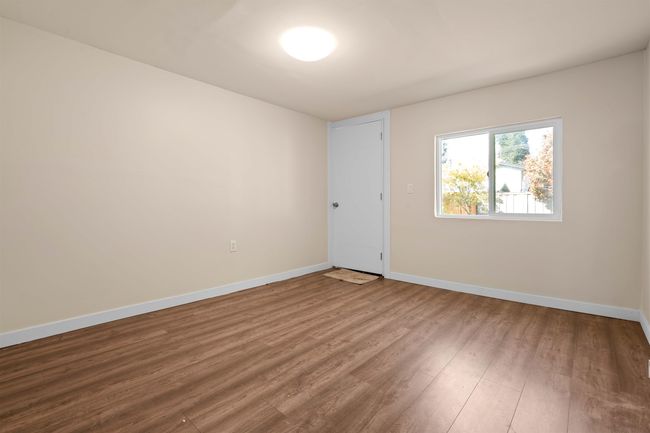 Empty room with baseboards and wood finished floors | Image 11