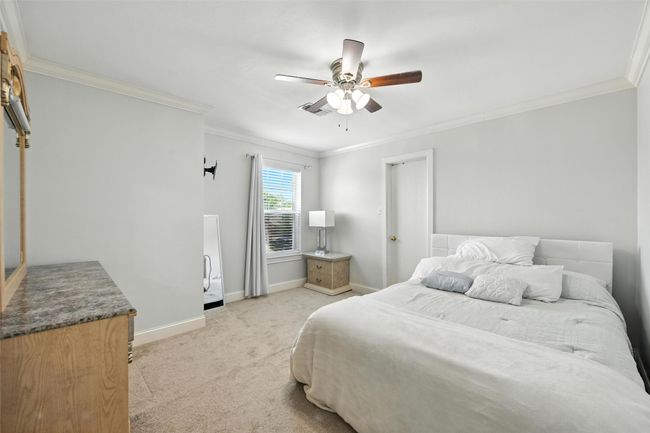 Bedroom featuring crown molding, light carpet, and ceiling fan | Image 21