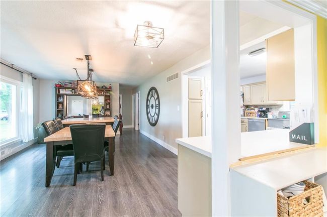 Dining area featuring dark wood finished floors and baseboards | Image 21