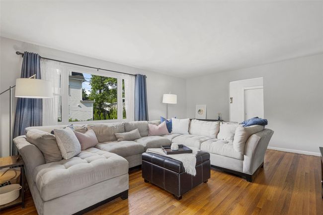 Living area with wood finished floors and baseboards | Image 6