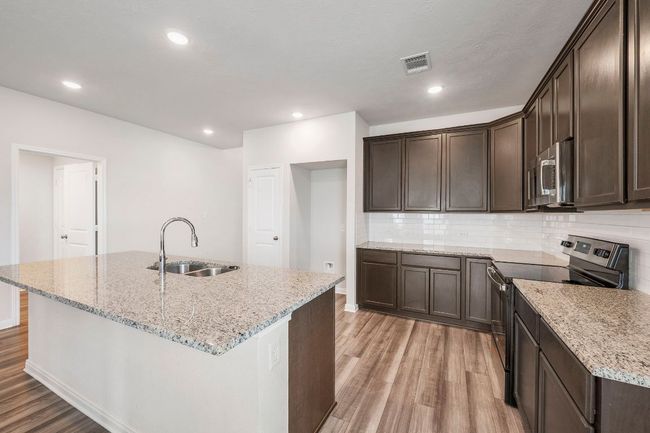 Ample storage and prep space with modern finishes and convenient layout for everyday function. | Image 7