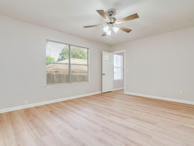 Empty room with light wood-type flooring and ceiling fan | Image 18