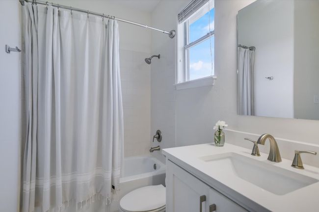 Full bath featuring vanity and shower / bath combination with curtain | Image 12