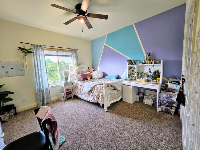 Carpeted bedroom with ceiling fan and baseboards | Image 33