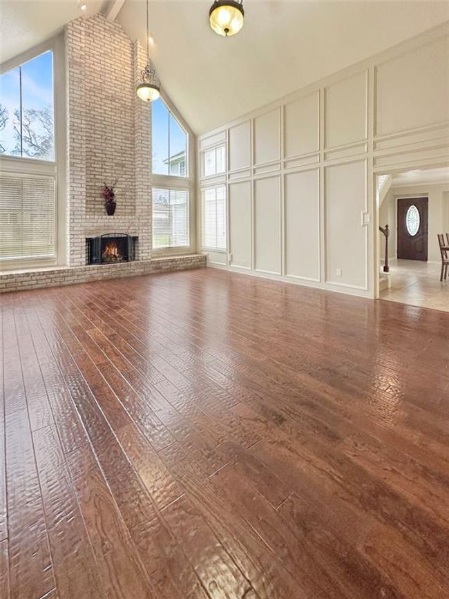 View from entry-The cathedral ceiling stretches high, creating an open and airy atmosphere. The soaring height enhances the feeling of space, making the room a perfect gathering spot for family and friends. | Image 7