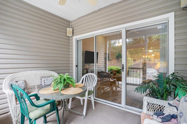 Sunroom featuring ceiling fan | Image 27