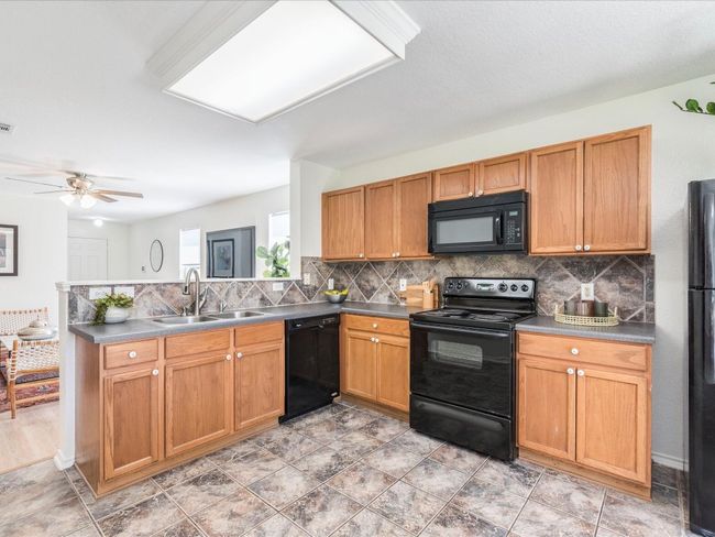 . The bright and spacious kitchen overlooks the main living area making it easy to stay connected. | Image 13