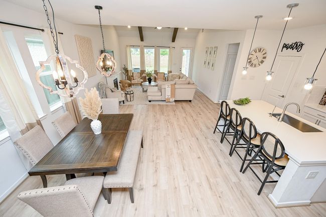 The home boasts an open and airy layout with elevated ceilings and cool-toned modern finishes throughout. | Image 7