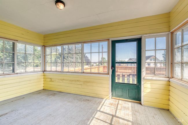 Unfurnished sunroom featuring wooden walls, healthy amount of natural light, and wood finished floors | Image 27