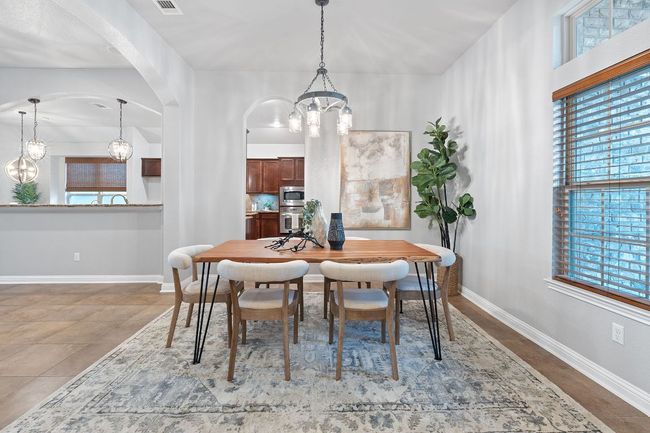 Dining area with a chandelier, arched walkways, and baseboards | Image 4