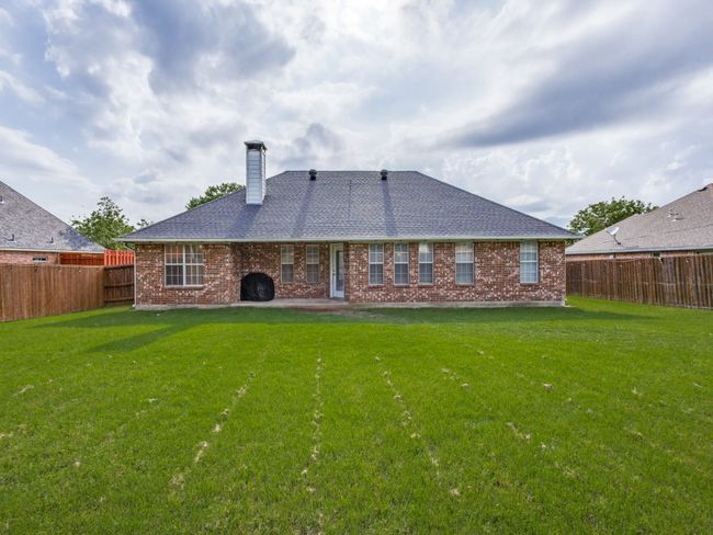 Back of house with a chimney, brick siding, and a shingled roof | Image 24