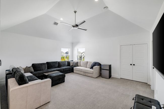 Living area featuring carpet, ceiling fan, recessed lighting, baseboards, and high vaulted ceiling | Image 33