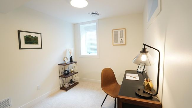 The lower level fourth bedroom is directly next to both the dry bar area and the lower level laundry and utility room. It is also down the hall from the family room, and just down the stairs from both the kitchen and powder room. | Image 32