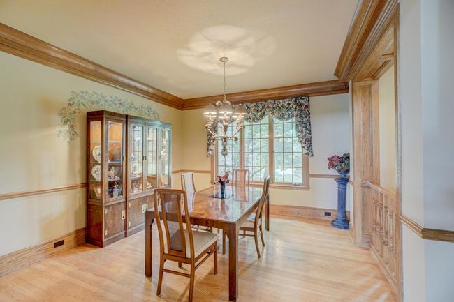 Take in the beautiful nature views while you enjoy meals or entertain from this formal dining space | Image 32