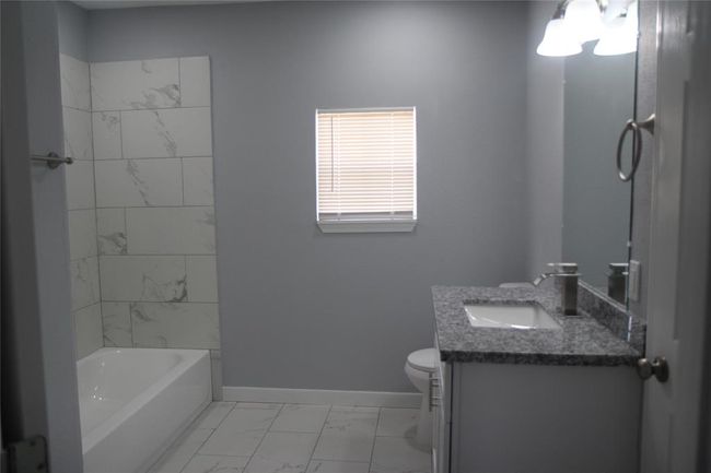 Bath located first door on the right from the living room | Image 15