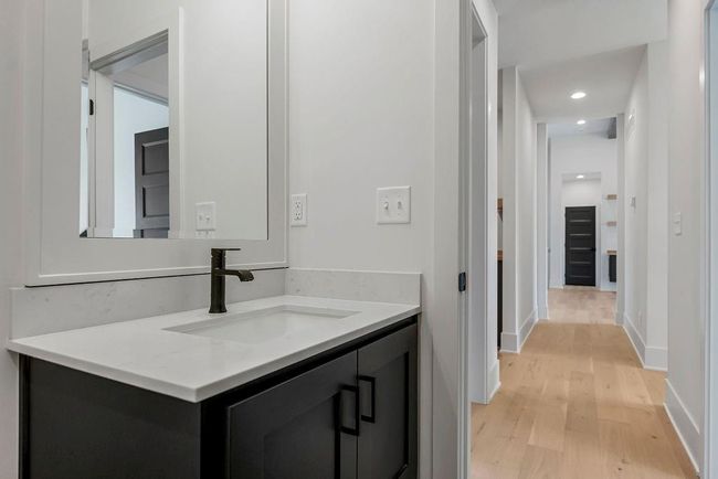 Bathroom with wood finished floors, vanity, baseboards, and recessed lighting | Image 14