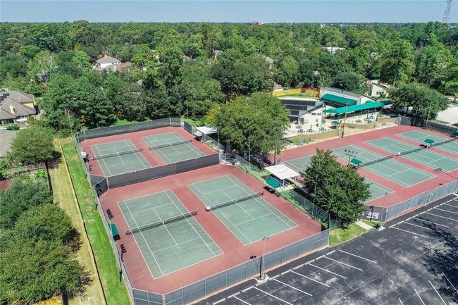 Optional racquet club membership includes access to a large pool. A must-see home with space, charm, and versatility! | Image 40