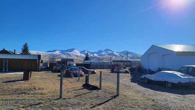 View of yard with a mountain view, a garage, and an outdoor structure | Image 18