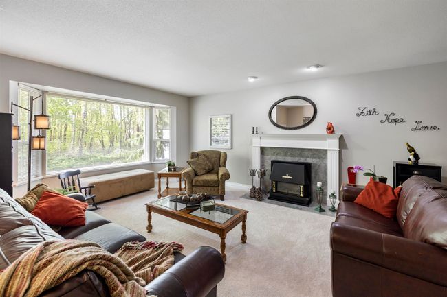 Living room with carpet flooring and a fireplace | Image 6