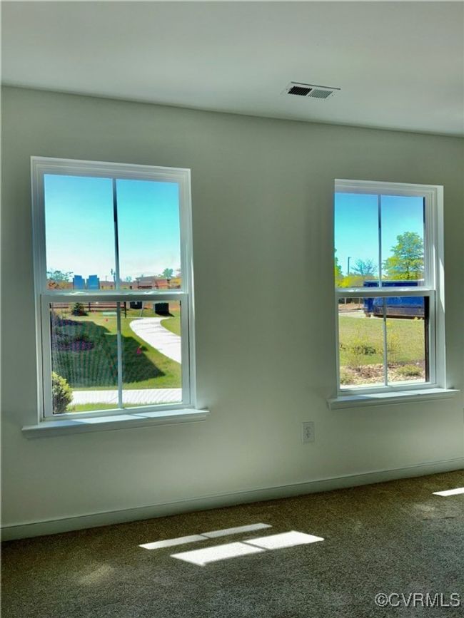 Spare room featuring visible vents, carpet flooring, and a healthy amount of sunlight | Image 14