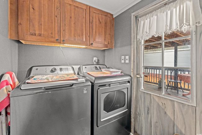 Laundry room featuring cabinets and separate washer and dryer | Image 14
