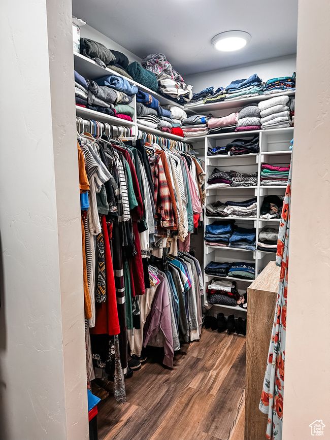 Walk in closet with wood finished floors | Image 19