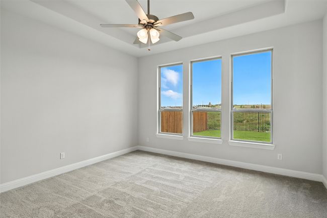 Carpeted spare room with baseboards and a ceiling fan | Image 14
