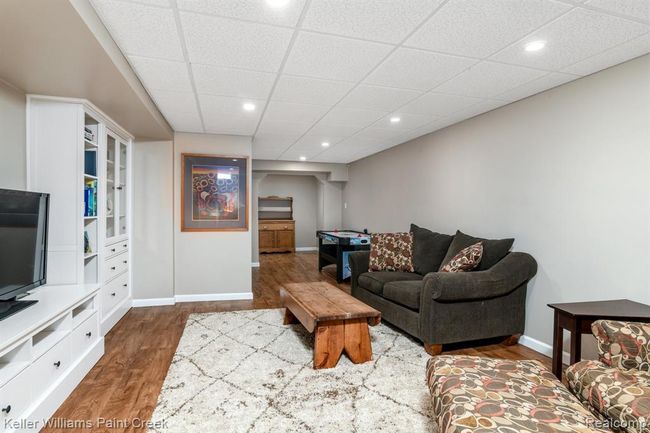 Lower level family room is cozy with updated decor and a spacious entertainment center. | Image 14