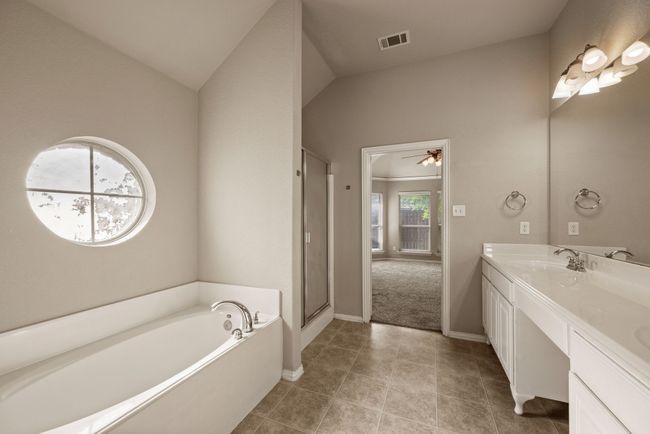 Bathroom with a sink, double vanity, a stall shower, visible vents, and a garden tub | Image 22