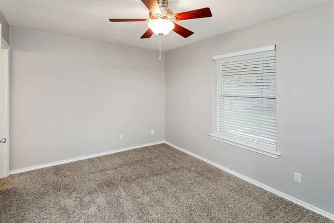 Spare room featuring a ceiling fan and carpet | Image 12