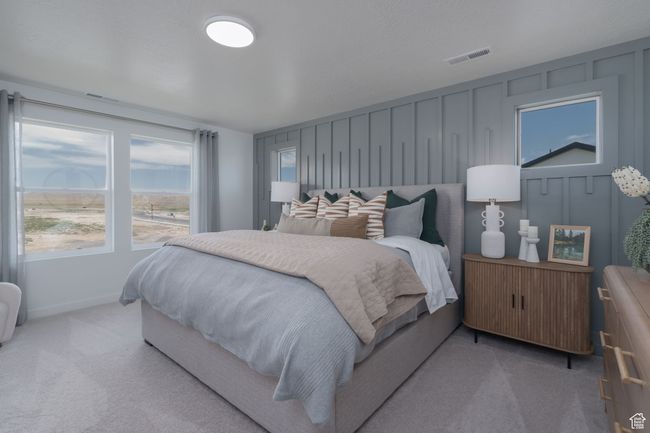 Bedroom with a decorative wall and carpet | Image 34