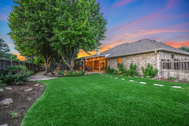 Yard at dusk featuring a patio area and a fenced backyard | Image 36