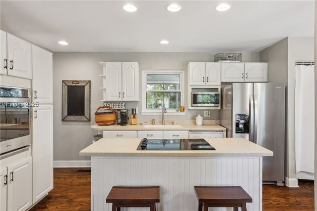 Updated chef's kitchen with stainless steel appliances & ample storage, efficient flow and a window over the sink for a view while prepping and cooking. | Image 14