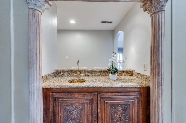 Bathroom with decorative columns, vanity, and visible vents | Image 19