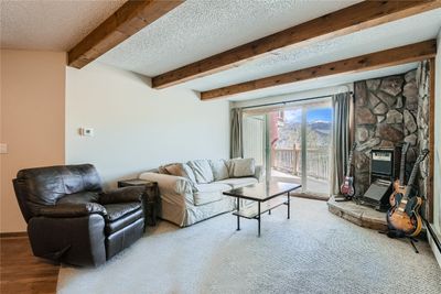 Living room featuring beamed ceiling | Image 3