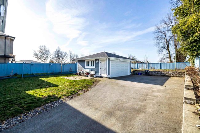 Exterior space with a garage, driveway, a yard, and fence | Image 24