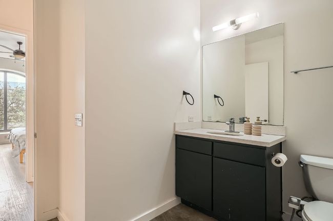 Bathroom with ensuite bathroom, baseboards, toilet, wood finished floors, and vanity | Image 16