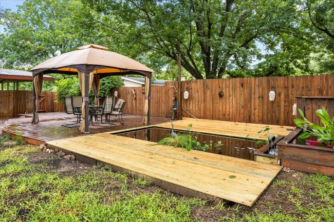 Deck featuring a gazebo, a fenced backyard, and outdoor dining space | Image 27