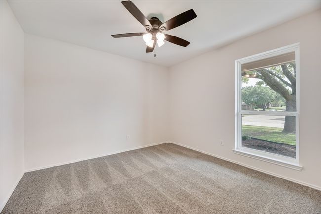 Carpeted empty room with a ceiling fan and baseboards | Image 17
