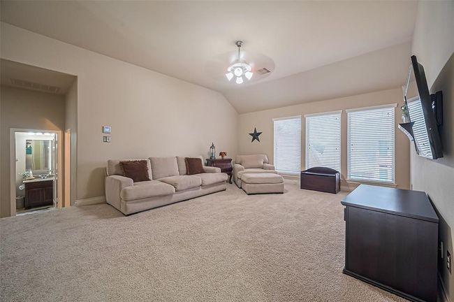 Enhanced by a ceiling fan, this versatile room is perfect as a playroom, entertainment center, or casual gathering spot. | Image 30