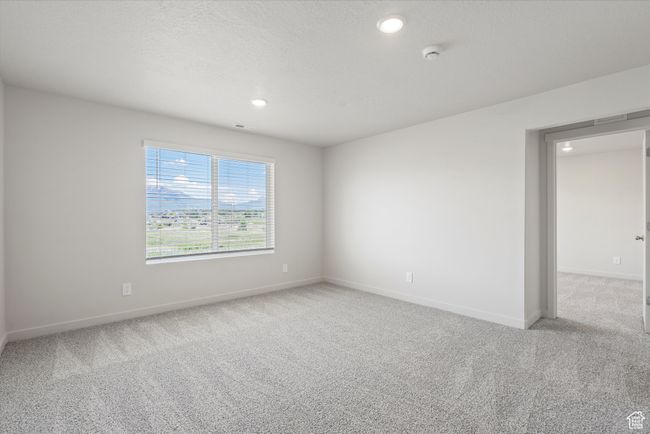 Empty room featuring carpet flooring, a smoke detector, and recessed lighting | Image 28