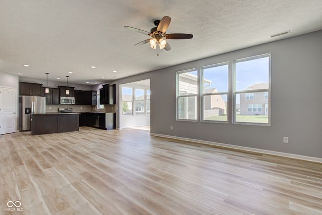 unfurnished living room with a ceiling fan, light wood-style floors, and recessed lighting | Image 4