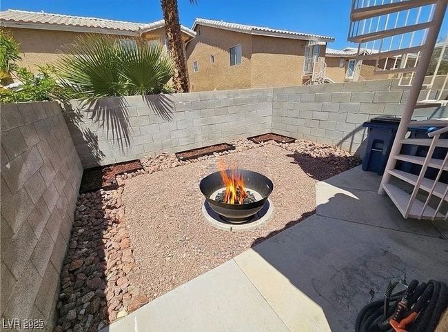 Fenced backyard with an outdoor fire pit and a patio | Image 25