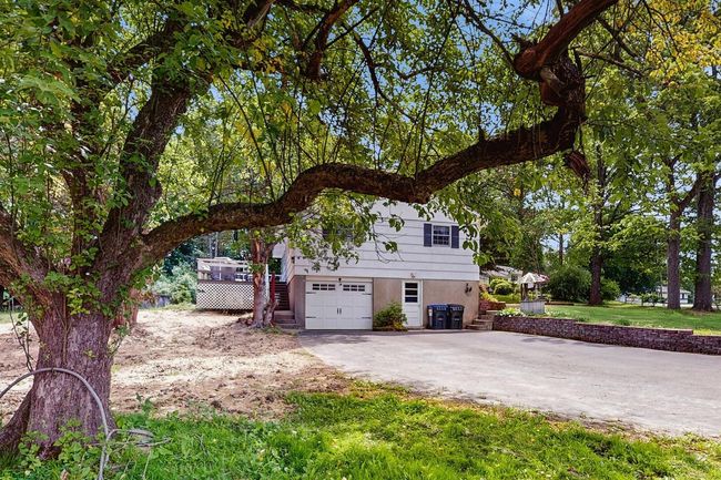 View of front of property with stairway, driveway, an attached, 1 car garage. | Image 37