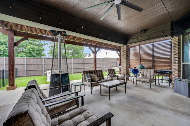 Fenced backyard with an outdoor hangout area, a ceiling fan, a patio area, and area for grilling | Image 28
