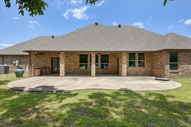 Back of house with a shingled roof, brick siding, and a lawn | Image 32